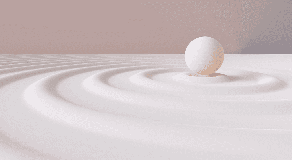 A smooth sphere resting at the centre of rippling sand
